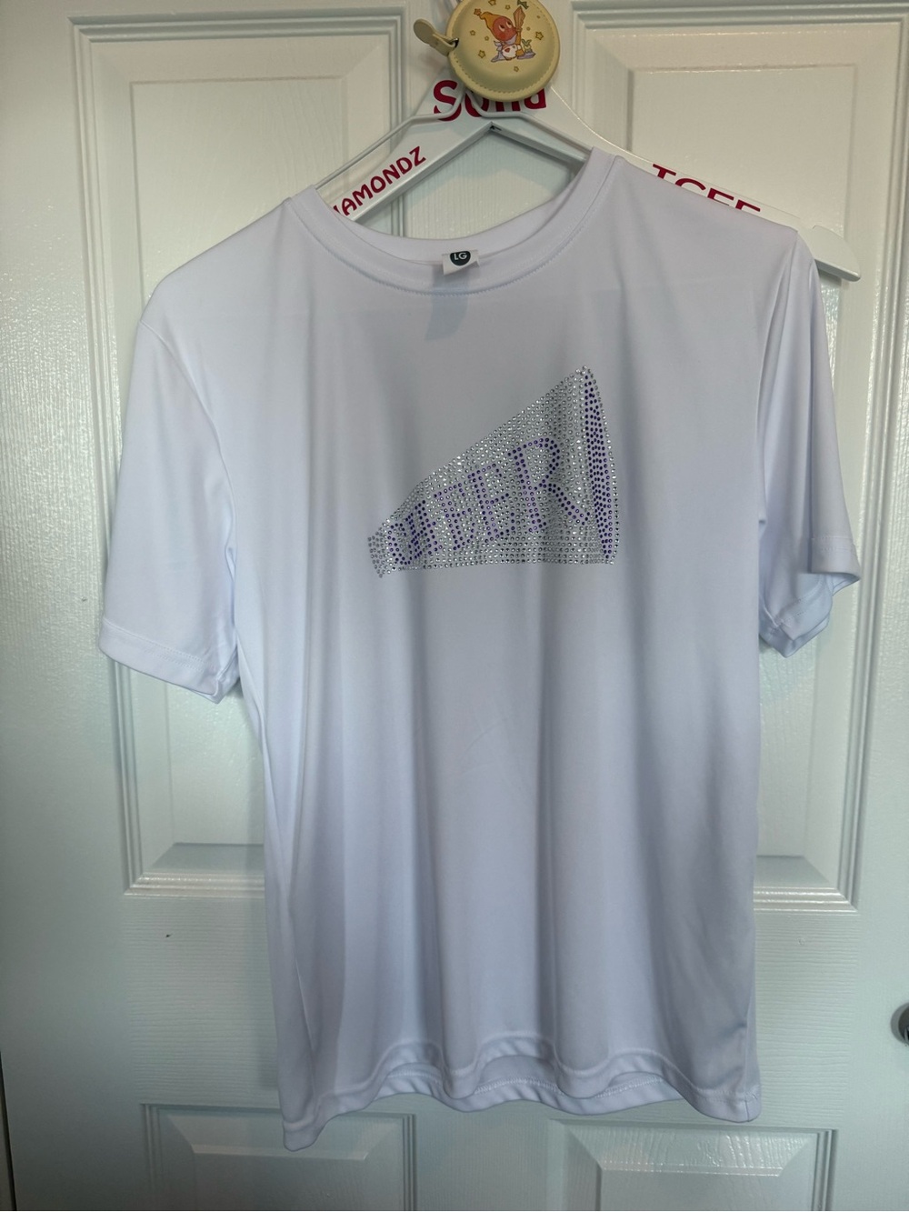 girl white dry fit tee with purple cheer megaphone in rhinestones